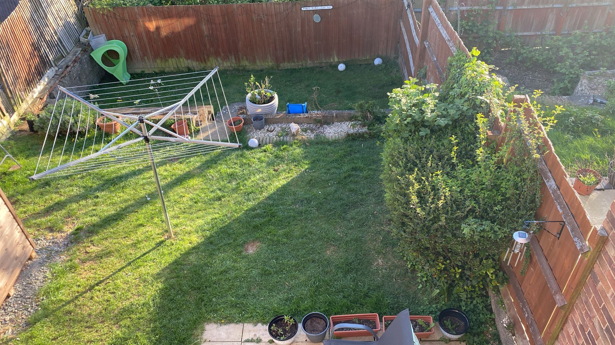 Original patio, lawn edge and side planting before landscaping