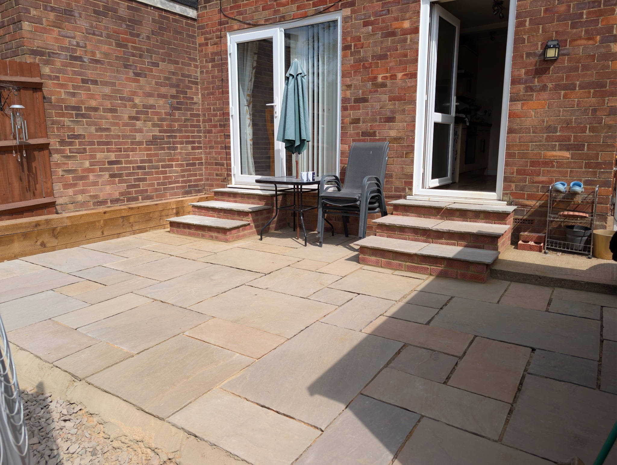 Expanded paved seating area taking shape beside the house