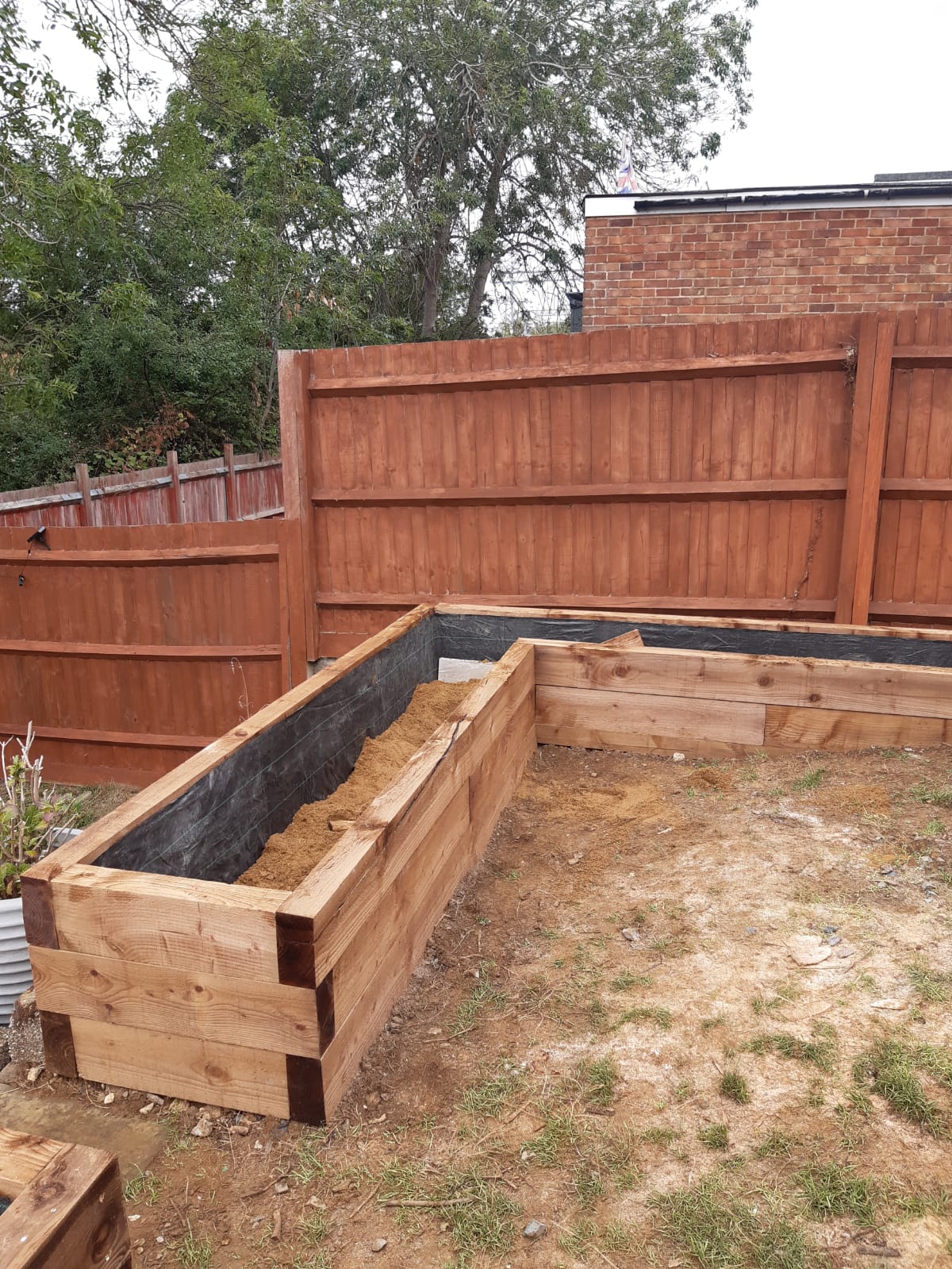 New timber retaining beds installed along the garden boundary